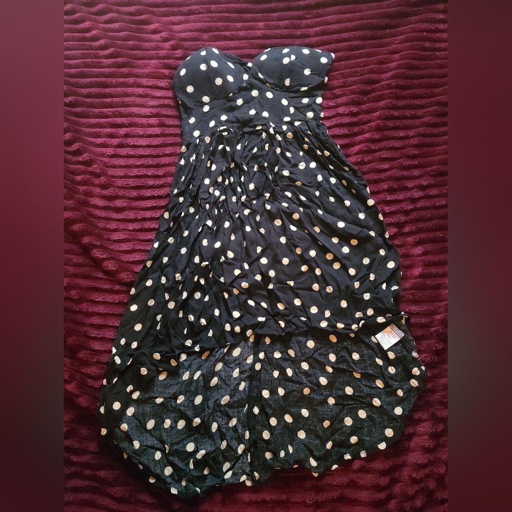 A black dress with white or cream polkadot